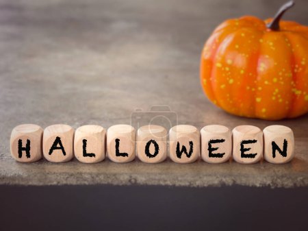 Photo for October celebration and Halloween concept. HALLOWEEN written on wooden blocks. With blurred styled background. - Royalty Free Image