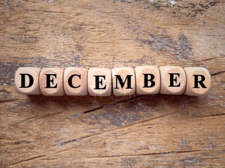 Photo for Month, time and celebration concept. DECEMBER written on wooden blocks. With blurred styled background. - Royalty Free Image