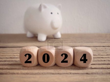 Photo for New Year financial plan concept. 2024 written on wooden blocks. With blurred styled background. - Royalty Free Image