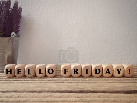 Photo for Motivational and inspirational wording. Weekend vibes concept. HELLO FRIDAY written on wooden blocks. With blurred vintage styled background. - Royalty Free Image