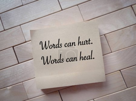 Photo for Motivational and inspirational wording. Words can hurt, Words can heal written on a notepad. With blurred style background. - Royalty Free Image