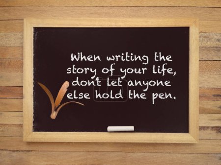 Photo for Motivational and inspirational wording. When Writing The Story Of Your Life, Dont Let Anyone Else Hold The Pen written on a blackboard. With blurred styled background. - Royalty Free Image