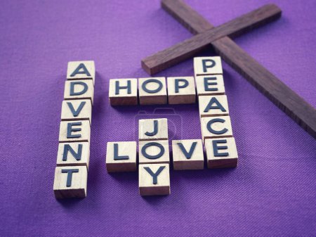 Photo for Christianity concept about Advent and Christmas season. ADVENT, HOPE, PEACE, LOVE, JOY written on wooden blocks. With blurred style background. - Royalty Free Image