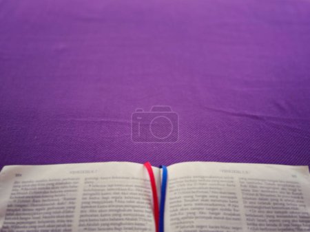 Christianity concept about church Liturgy, Ash Wednesday, Good Friday, Lent Season and Holy Week. A holy bible arranged on purple background, blurred.
