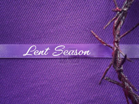 Christianity concept about Ash Wednesday, Good Friday, Lent Season and Holy Week. Lent Season written on a purple ribbon. With blurred style background.
