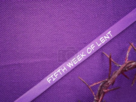 Christianity concept about Ash Wednesday, Good Friday, Lent Season and Holy Week. FIFTH WEEK OF LENT written on a purple ribbon. With blurred style background.