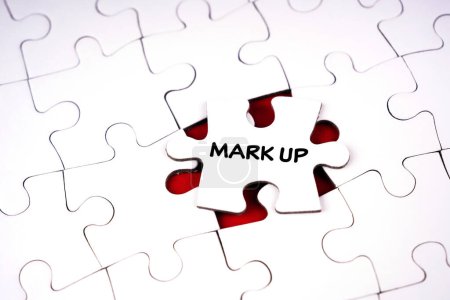 Business and management concept. MARK UP written on jigsaw puzzle piece. Blurred styled background.