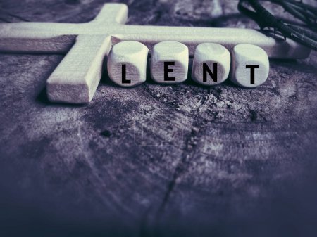 Lent Season,Holy Week and Good Friday concepts - word lent on wooden cubes in purple vintage background. Stock photo.