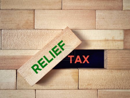 Tax relief with wooden blocks background. Business and economy concept.