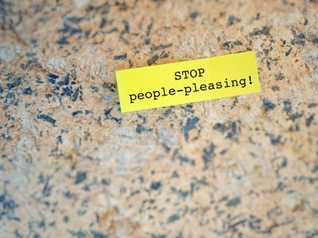 Photo for Stop people-pleasing text on yellow notepaper background. - Royalty Free Image