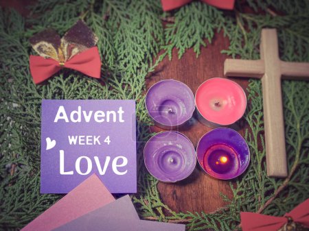 Photo for Advent week 4 love text on paper with the purple candle lit background. Advent Season Concept. - Royalty Free Image