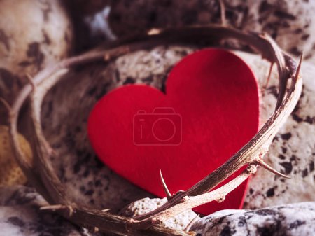 Photo for Lent, Holy Week, Good Friday, Easter Sunday Concept - Crown of thorns with blurry red heart shape and stone background. - Royalty Free Image