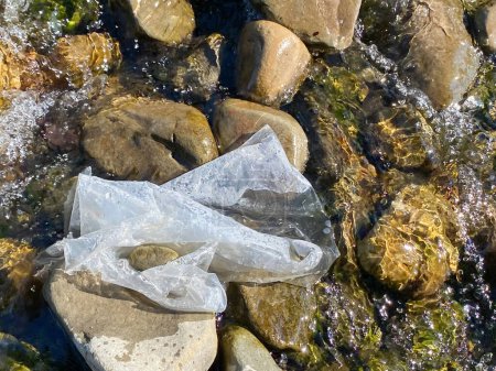 Plastic pollution in river background. Environmental issues. Stock photo.