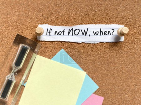 Motivational success concept - if not now when? Note written on torn paper background. Stock photo.