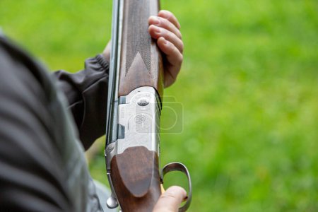 Photo for Ukraine. Kyiv. September 22, 2022 .Beretta  Double Barrel Shotgun Close UpSkeet Shooting .Man shooting at target on an outdoor shooting range at sunny day, training alone, confident and skilled, experienced. Shooting and Guns. - Royalty Free Image