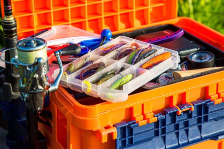 A large fisherman's tackle box fully stocked with lures and gear for fishing.fishing lures and accessories.Fishing tackle - fishing spinning. Kit of fishing lures.