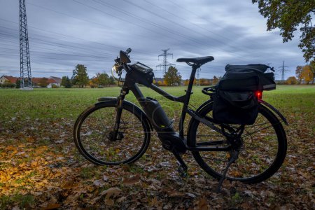 Foto de Bicicleta eléctrica negra en pradera verde de otoño cerca de la ciudad de Nemanice CZ 10 31 2023 - Imagen libre de derechos