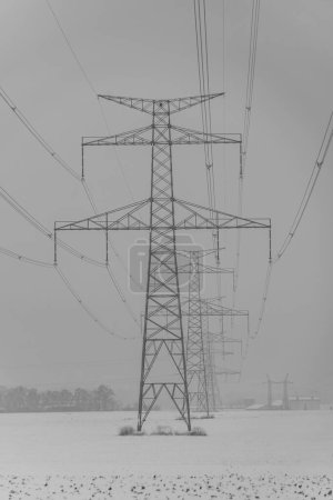Photo for Rana hill in white storm snowy morning near Louny town with high voltage electric post - Royalty Free Image
