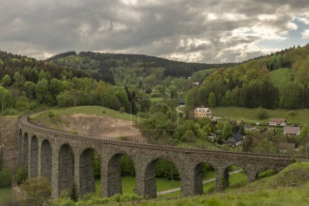 Old stone viaduct near in spring cloudy evening near Novina mountains village