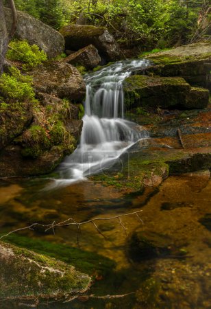Jeleni waterfall in spring sunny cloudy day in fresh color Jizerske mountains