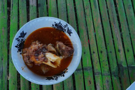 Photo for Spicy Foot cow soup is the Indonesian traditional soup especially found in Madura Island, East Java - Royalty Free Image