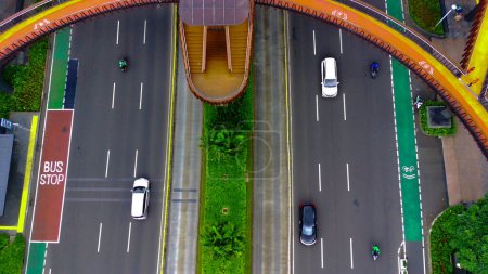 Foto de 4 February 2023. Pedestrian Bridge named Phinisi on Sudirman Street, Jakarta. Indonesia. Aerial footage taken by drone. - Imagen libre de derechos