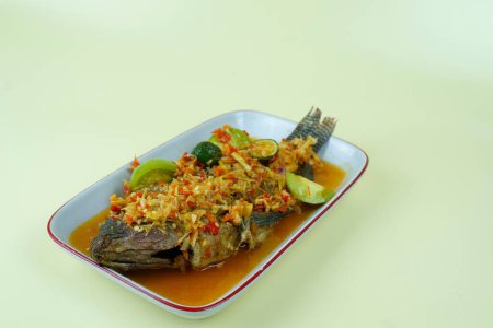 Photo for Pecak Ikan Mujair Betawi is a traditional Indonesian dish that originated from Betawi, the native people of Jakarta, Indonesia. Isolated and copy space. - Royalty Free Image