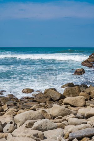 Photo for Pantai Klayar or Klayar Beach with rocks and strong waves against the blue sky. Motion blur. Landscape photography. - Royalty Free Image