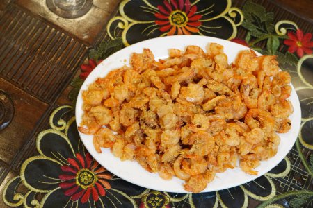 Photo for Crispy fried shrimps served on white plate for lunch on the table. - Royalty Free Image