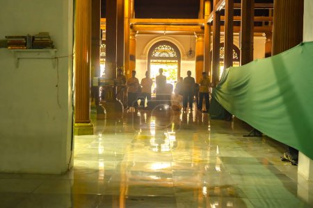 Photo for July 8, 2023. eople praying, reading Al Qur'an, chatting, sleeping inside Mesjid Sunan Ample or Sunan Ample Mosque in Surabaya, Indonesia. - Royalty Free Image