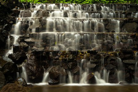 Photo for Landscape of multilevel waterfalls in Dlundung, Trawas, Mojokerto. Indonesia. Long Exposure Nature Photography. - Royalty Free Image
