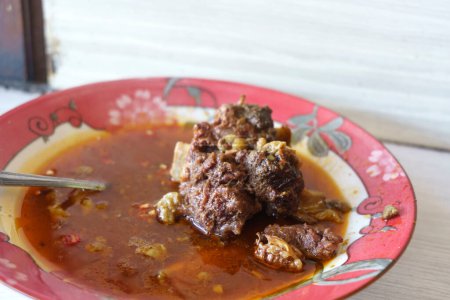 Photo for Gule Balungan Kambing Madura is a savory Indonesian dish that features Madurese style goat ribs stewed in a fragrant and flavorful curry like broth. Food Photography. - Royalty Free Image