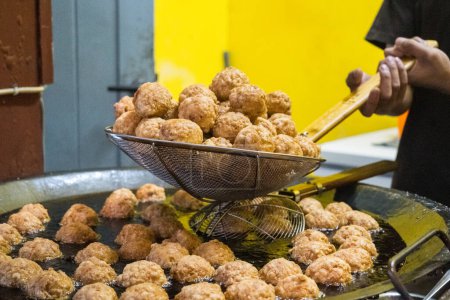 Photo for Bakso Goreng or fried meatball delights offer a satisfying crunch on the outside, revealing a savory explosion of tastes within. A beloved local delicacy, this dish embodies Malang's culinary heritage, inviting you to experience a perfect blend of te - Royalty Free Image