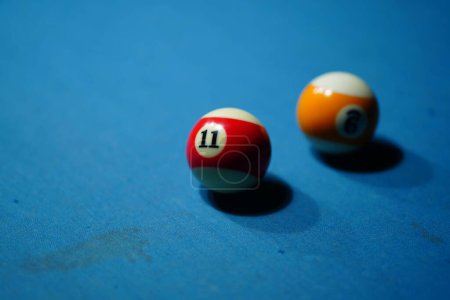 Photo for After being struck on the billiard table in a game of billiards, several billiard balls. Sport and game photography - Royalty Free Image