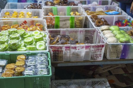 Photo for Many varieties of traditional snacks sold in the Marketplace in dawn time in Surabaya, East Java, Indonesia. Street Food Photo - Royalty Free Image