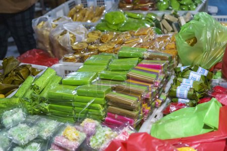 Photo for Many varieties of traditional snacks sold in the Marketplace in dawn time in Surabaya, East Java, Indonesia. Street Food Photo - Royalty Free Image