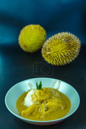Photo for Kinca durian or sticky rice with thick durian sauce is served with palm sugar and coconut milk. Sepacial sweet food from Indonesia. - Royalty Free Image