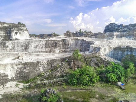 Panoramic landscape of Bukit Jaddih or Jaddih Hills, Bangkalan, Madura Island with white limestone cliffs and blue sky