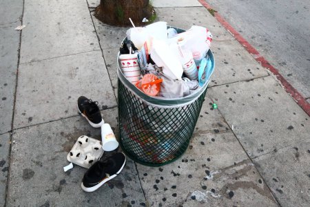 Photo for Hollywood, California - October 6, 2019: full garbage can on Sunset Boulevard, Hollywood - Royalty Free Image