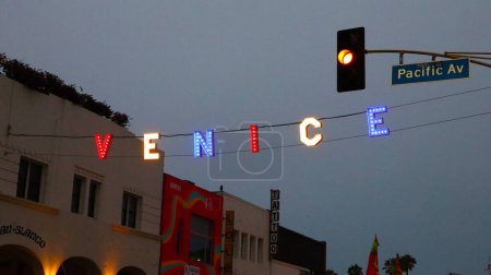 Photo for Venice Beach (Los Angeles), California  July 1, 2023: VENICE Sign by night at the intersection of Windward Ave and Pacific Ave - Royalty Free Image