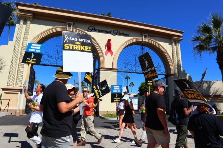 Photo for Los Angeles, California, United States. 5th Oct, 2023. Striking Members of SAG-AFTRA and other union supporters picket outside Paramount Pictures on Melrose Ave. Nearly all television or film actors joined the Writers Guild of America - Royalty Free Image