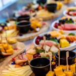 fresh fruit and cheese on wooden buffet.