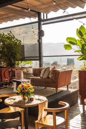 Téléchargez les photos : Beau et élégant cadre de table sur un toit de l'hôtel. Fleurs, vue et élégance. - en image libre de droit