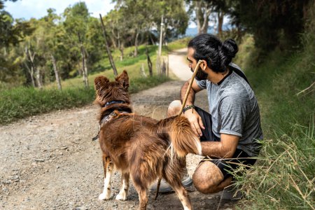 attentive border collie dog ready to run with adult mongrel man