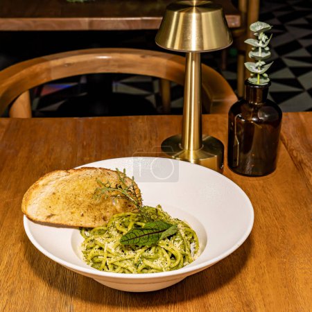 Pasta verde con queso parmesano y pan especiado. Pesto y espinacas. Restaurante del hotel gourmet.