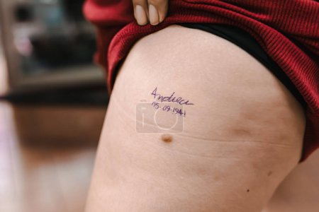 Photo for Name tattooed on young woman's leg. Tattoos, professional, art. - Royalty Free Image