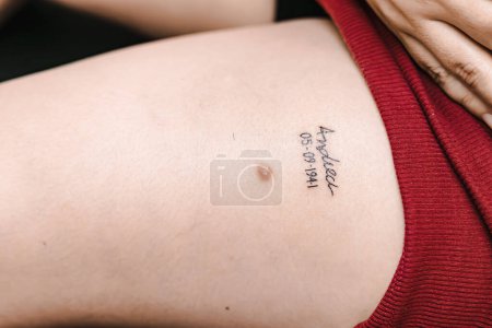 Photo for Name tattooed on young woman's leg. Tattoos, professional, art.name tattooed on young woman's leg. Tattoos, professional, art. - Royalty Free Image