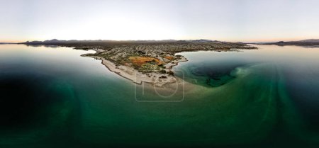 Photo for Wide angle view from aerial view drone shot of lake mohave in the national recreation area of lake mead in nevada and arizona with the sun setting showing six mile cove and its sand - Royalty Free Image