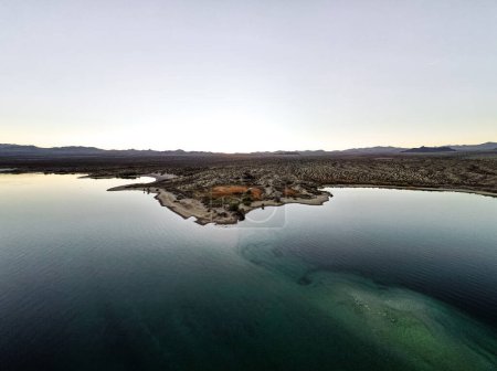 Photo for Wide angle view from aerial view drone shot of lake mohave in the national recreation area of lake mead in nevada and arizona with the sun setting showing six mile cove and its sand - Royalty Free Image
