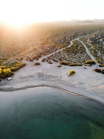 Photo for Aerial view drone shot of lake mohave in the national recreation area of lake mead in nevada and arizona with the sun setting showing six mile cove and its sand - Royalty Free Image